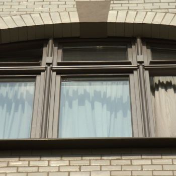 Dreiteiliges braunes Holzfenster mit Bogenform – elegante Ausführung für Fassaden historischer Gebäude